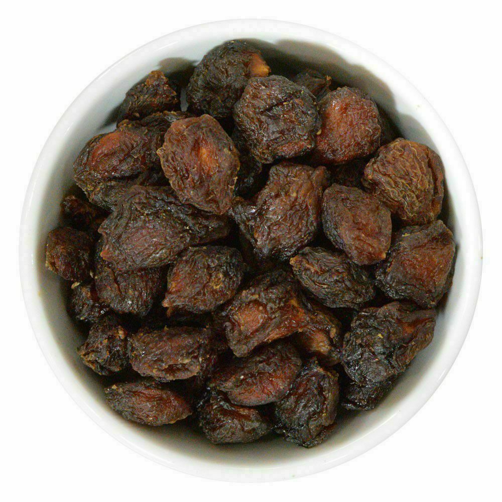 Dried plums in a rustic bowl